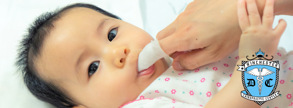 Dr. Henrickson is evaluating a child patient with an oral exam.